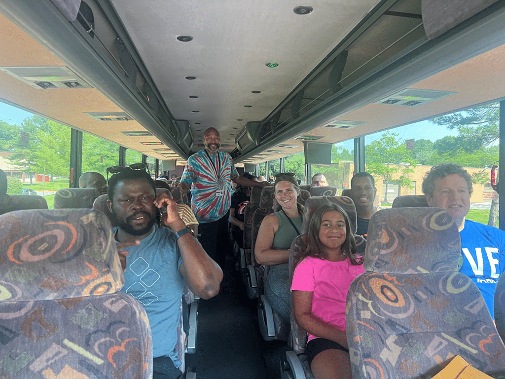 Members of adult residential services sitting inside of a bus.